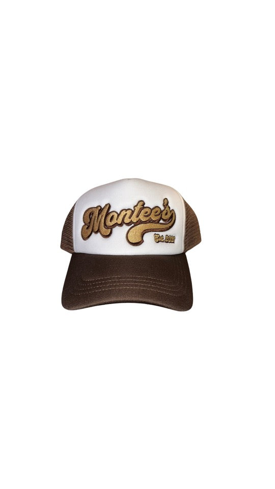 Montee’s Trucker Hat – Streetwear-inspired hat with mesh back and bold front logo. Perfect for adding an edge to any casual look. Front