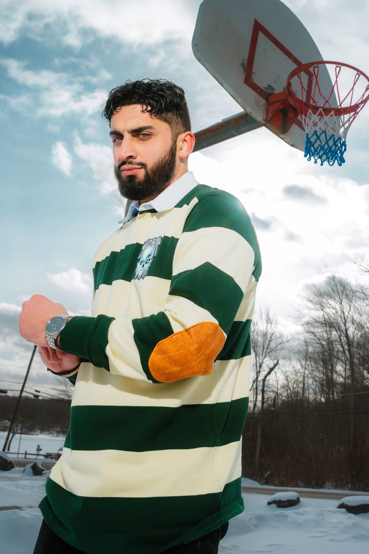 Ski Boyz Rugby shirt featuring bold stripes, embroidered skull patch, elbow patches, and screen-printed name and number for a street-inspired athletic look.