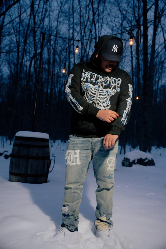 Ski Boyz 'Bone-Chill' Hoodie with frozen rib cage graphic on chest, icy arm designs on sleeves, made from heavyweight cotton for streetwear style.